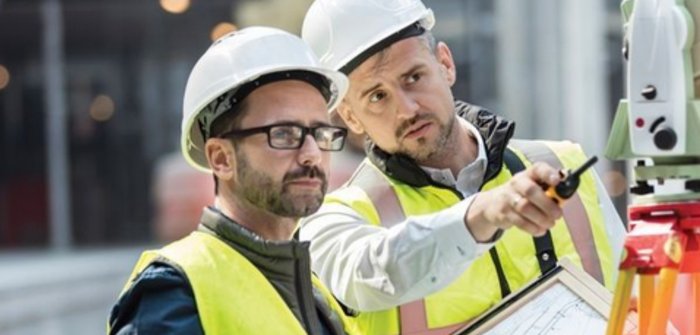 Engineers reviewing system readings on site to diagnose efficiency gaps