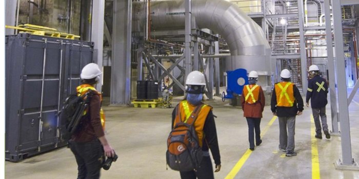 Field team walking through an industrial plant during a site measurement walkthrough