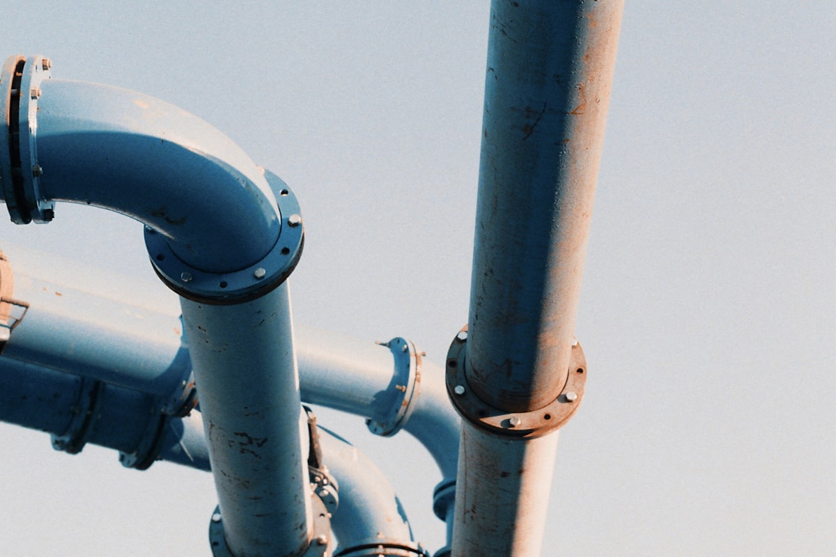 Industrial water pipes and flanges against the sky